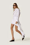 White loose dress with an asymmetric cut and flowing side detail