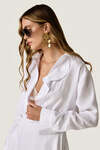 White loose dress with an asymmetric cut and flowing side detail