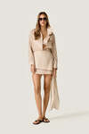Beige loose dress with an asymmetric cut and flowing side detail